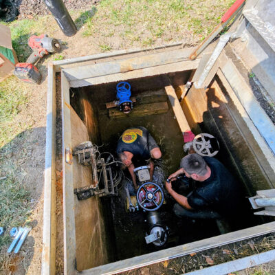 Toledo's Rooter Right Plumbing and Drain team is hard at work replacing a backflow system on a local sewer and drain line